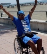 Arms raised beside the sea in Gran Canaria—feeling happy, free and grateful to be alive.