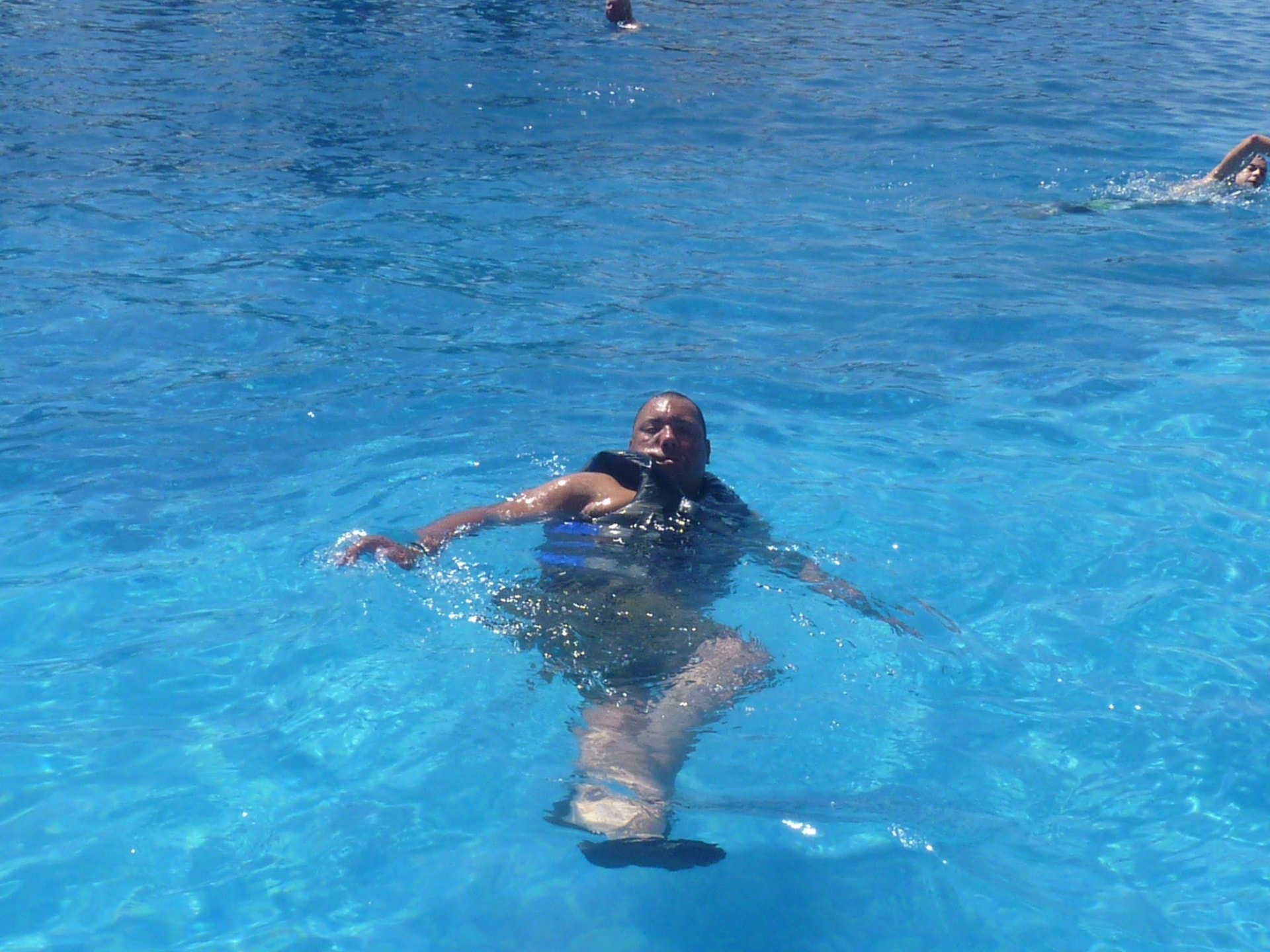Chris swimming in a deep blue pool