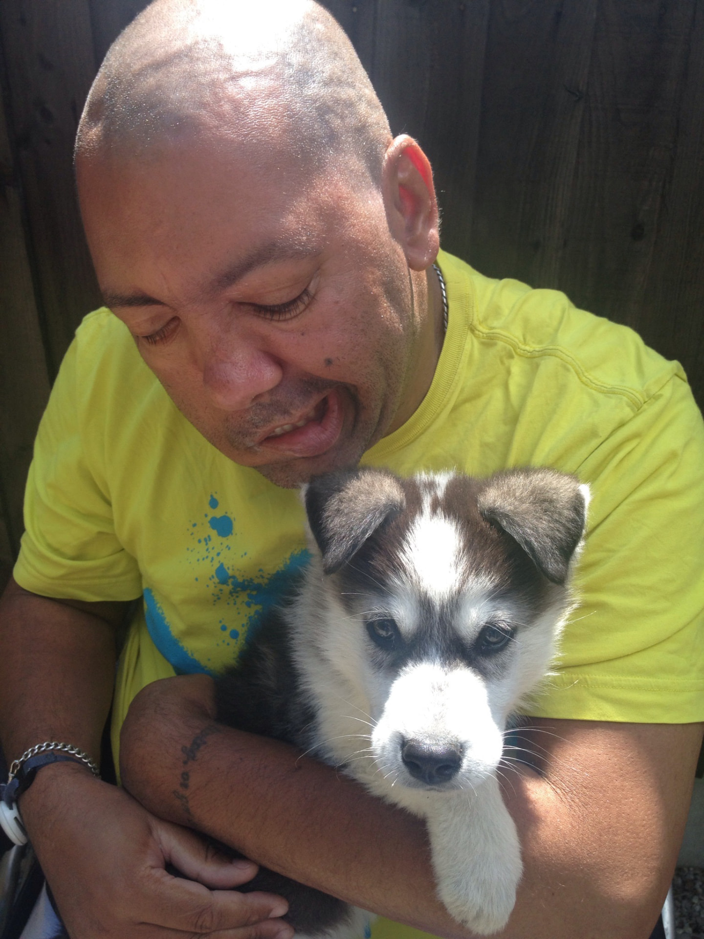 Holding my puppy Lucas, whom I loved dearly. I later had to sell him because my carers refused to help me look after him.