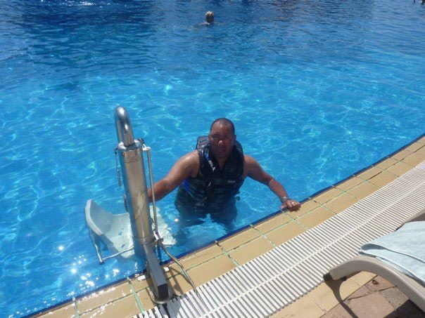 Chris at the poolside next to the pool hoist