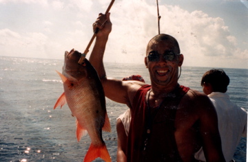 A proud moment fishing in Mexico—holding up my catch with a huge smile.