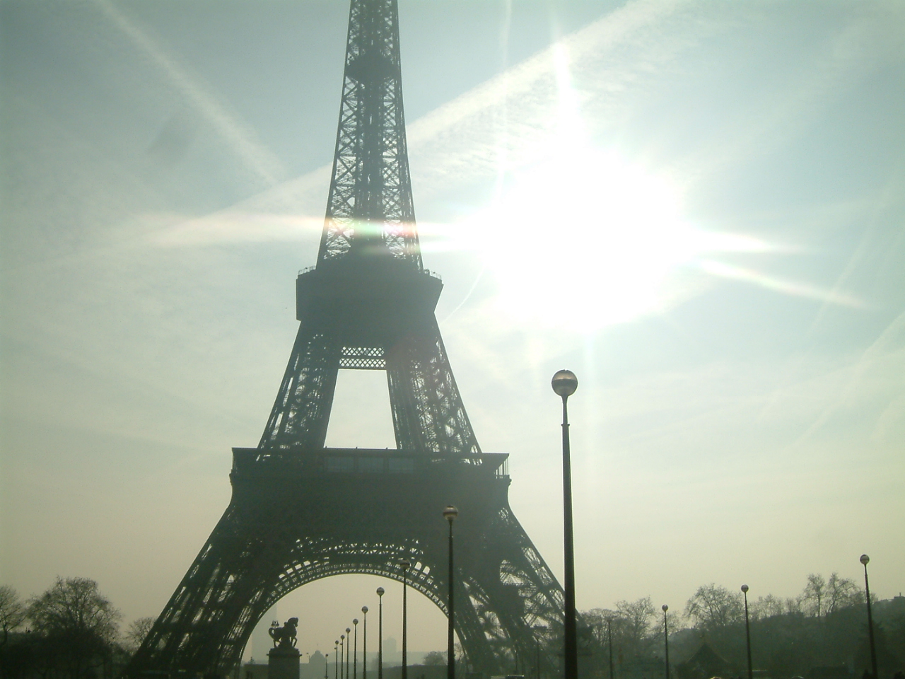 Looking up at the Eiffel Tower as sunlight filled the Paris sky—an unforgettable sight from a life-changing year.