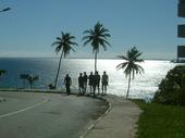 Walking with my friends towards the market in Brazil, with the sea and palm trees ahead of us.